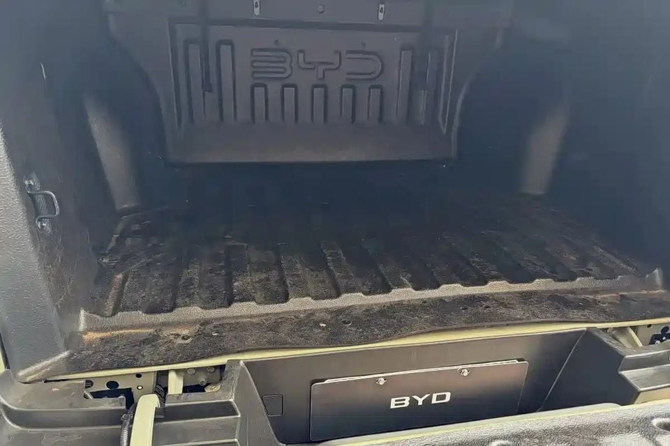 The open tub of a BYD Shark ute, showing the ribbed bed floor and BYD-branded tailgate and rear panel