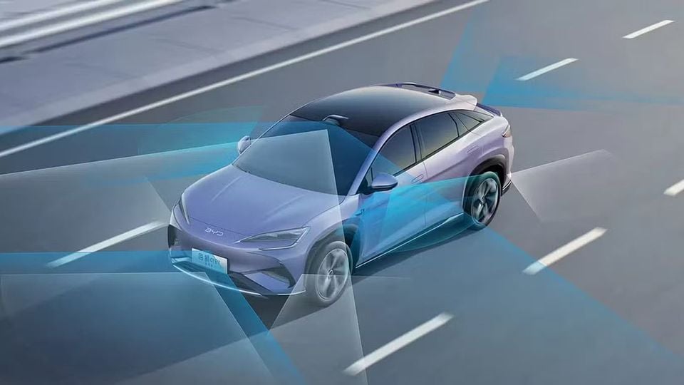 A BYD electric SUV driving on a highway, illustrated with blue sensor beams representing its advanced driver assistance system technology.