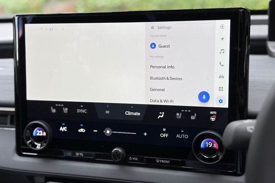 Touchscreen infotainment display in a Toyota BZ4X showing Android Auto settings menu, with climate controls visible below