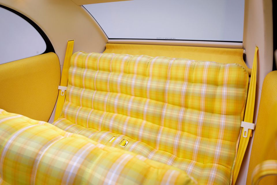 Yellow plaid bench rear seat with yellow seatbelts inside the Citroen 2CV concept