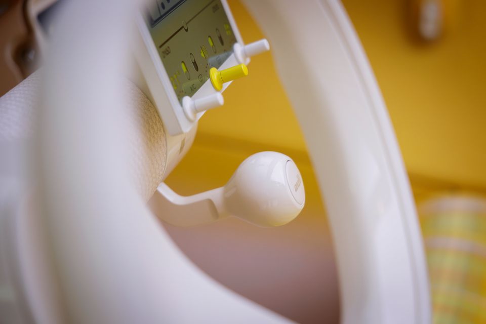 Close-up of the white steering wheel, toggle switch display and gear lever inside the Citroen 2CV concept car's cabin