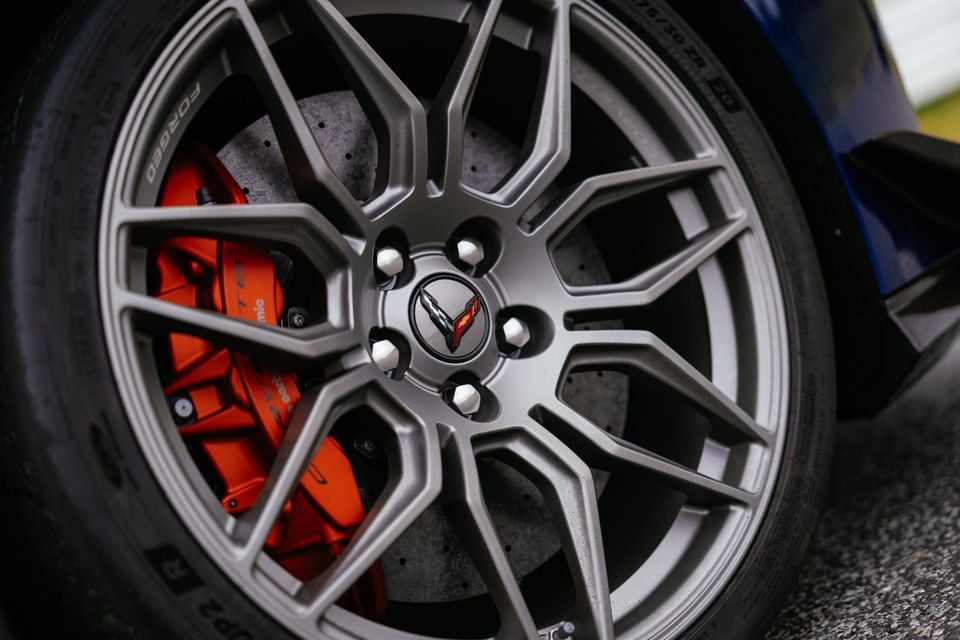 Close-up of a Chevrolet Corvette Z06's forged alloy wheel with an orange Brembo brake caliper