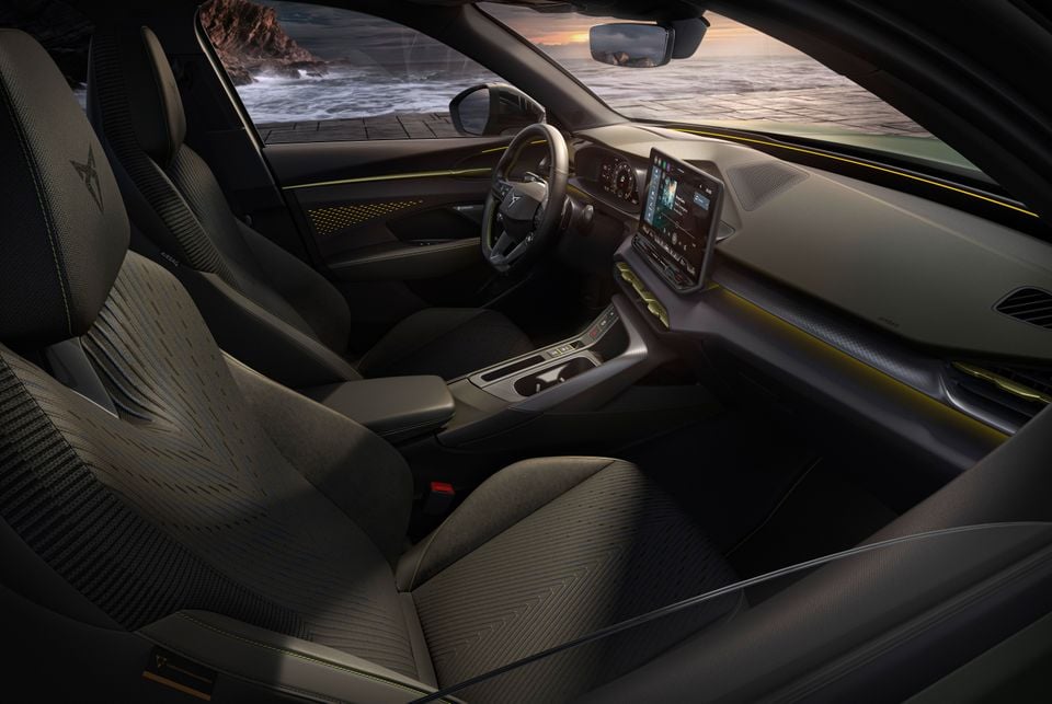 Interior of a Cupra Terramar VZ Tribe Edition showing the front cabin with patterned seats, large touchscreen infotainment display, digital instrument cluster, and yellow ambient lighting accents