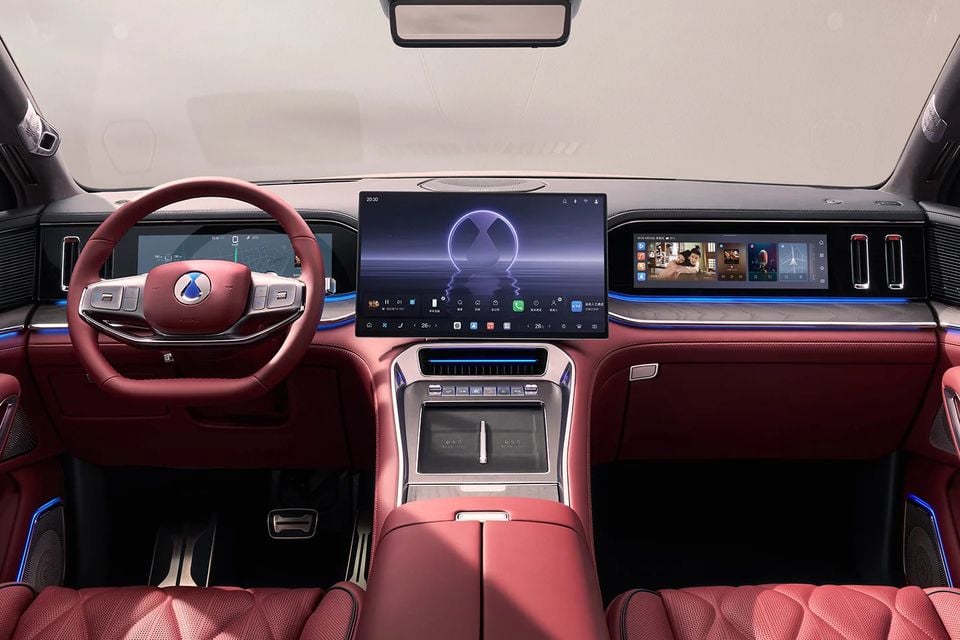 Denza N9 dashboard with red leather steering wheel, central touchscreen, passenger display and red leather front seats