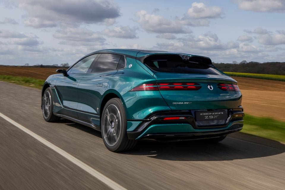 A green Denza Z9 GT shooting brake driving along a country road, seen from the rear