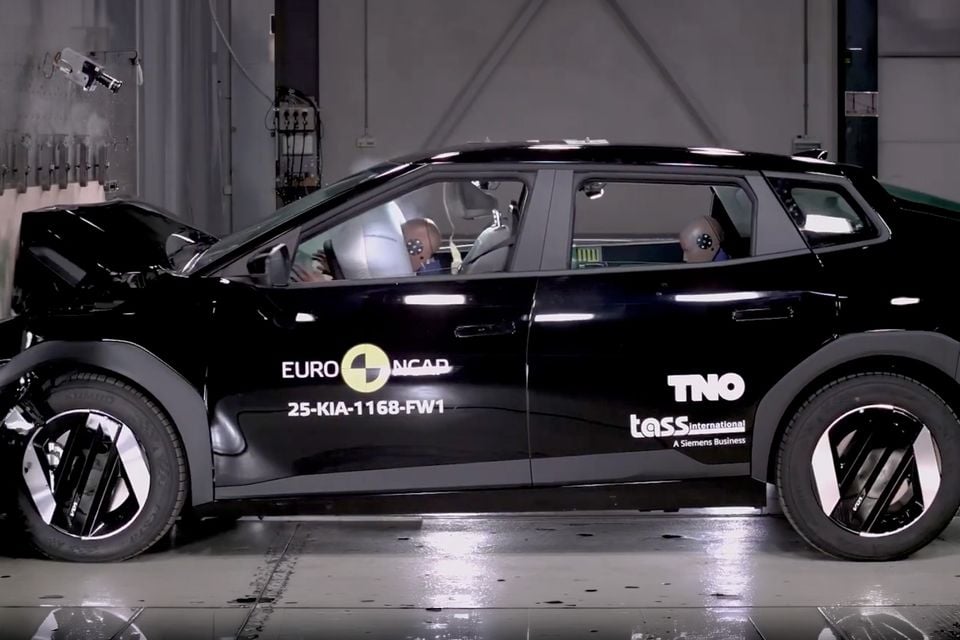 A Kia EV4 SUV undergoes a Euro NCAP frontal crash test, with airbags deployed and crash test dummies visible inside the vehicle