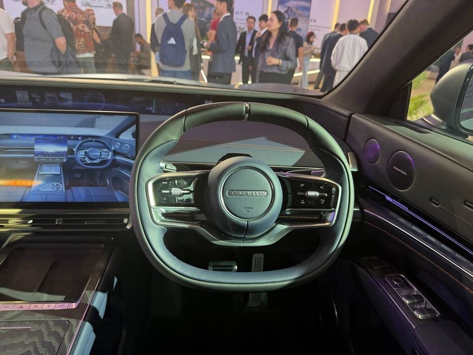 Exlantix-branded steering wheel on the right side of the cabin, with dashboard and central touchscreen displays visible.