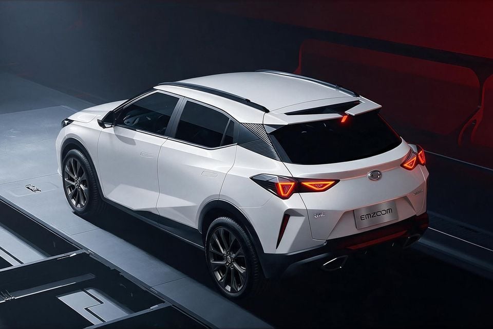 A white GAC Emzoom SUV seen from the rear three-quarter angle in a dramatic studio setting, showing its angular taillights and sloping roofline.