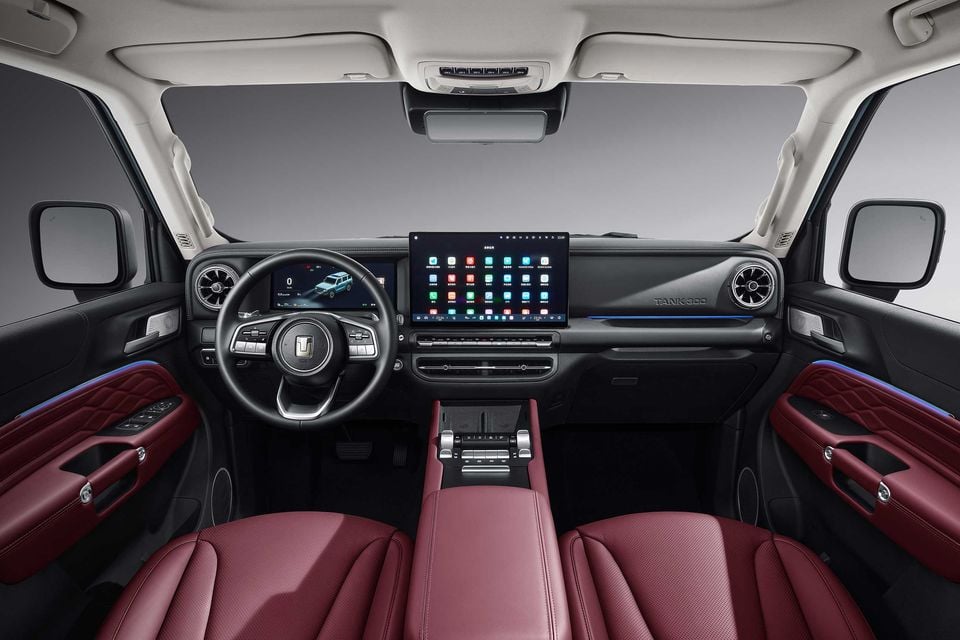 Interior of the GWM Tank 300 showing red leather seats, a large central touchscreen infotainment display, digital instrument cluster, and 'Tank 300' badging on the dashboard