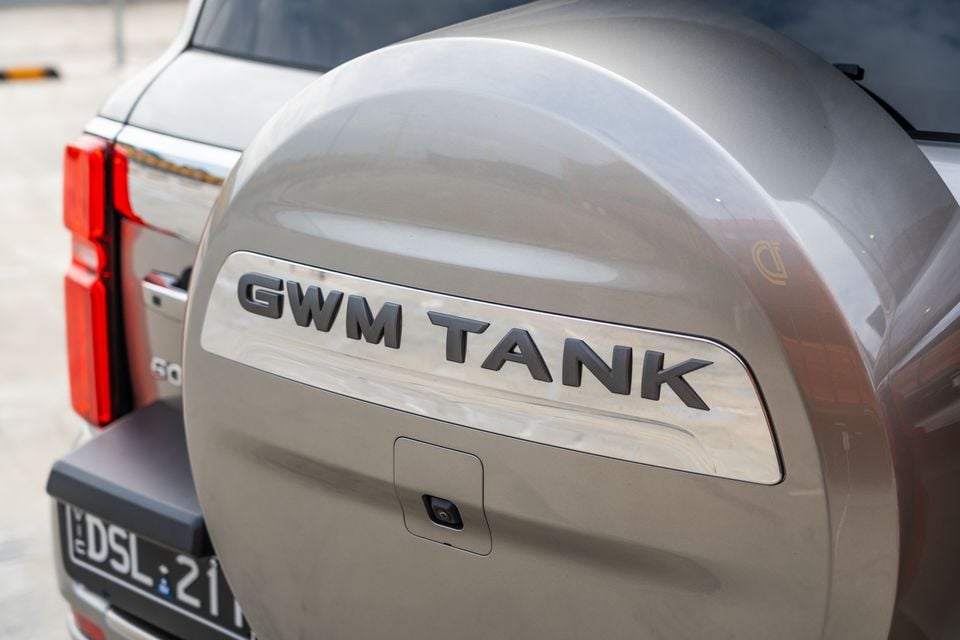 Close-up of the rear spare wheel cover on a GWM Tank 500, showing the GWM Tank badge and a rear-mounted camera