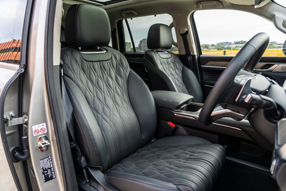 Black quilted leather front seats inside a GWM Tank 500 SUV, viewed from the open driver's door