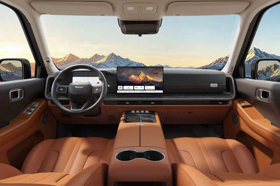 Interior of a Haval H10 showing tan leather seats, a large central touchscreen infotainment display, digital instrument cluster, and centre console