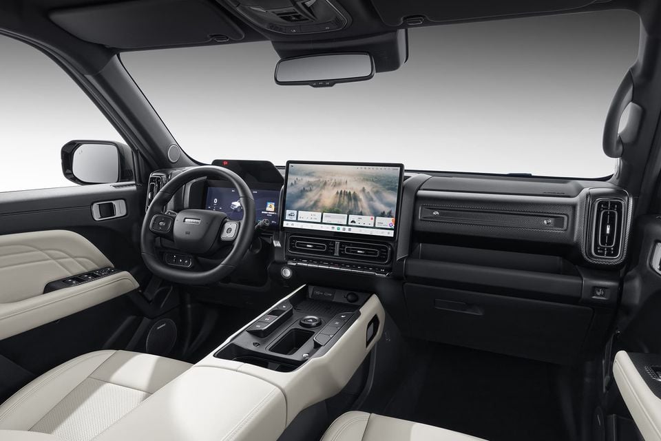Interior of the Haval Raptor Menglong H7 showing the dashboard, large central touchscreen infotainment display, steering wheel, centre console, and light-coloured leather seats