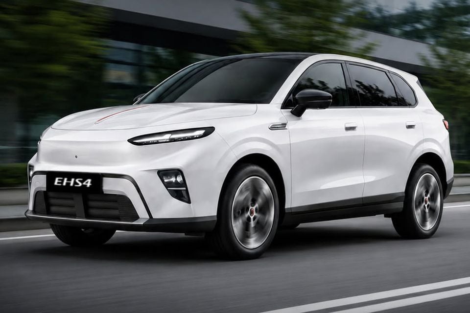A white Hongqi EHS4 electric SUV driving on a road, seen from the front quarter angle