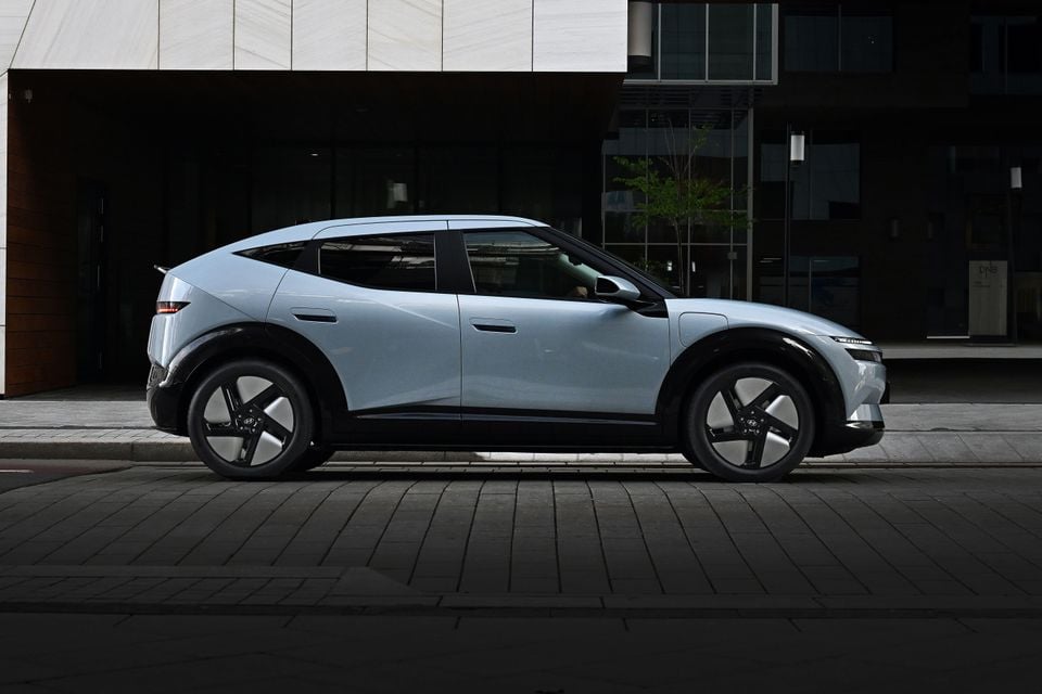 A light blue Hyundai Ioniq 5 electric SUV parked on a city street, seen from the side with its front pointing right.
