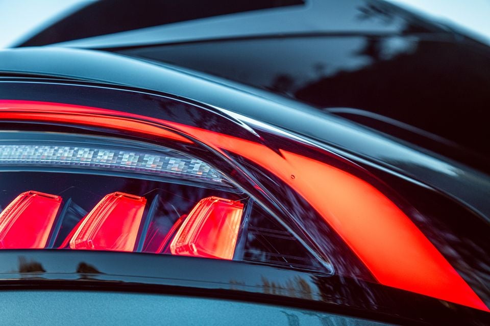 Close-up of the LED tail light on a Jaecoo J8, showing red lamp clusters and a bold red stripe across the rear body panel