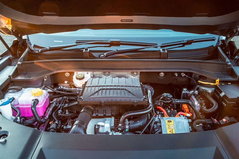Engine bay of a Jaecoo J8 with the bonnet open, showing the engine, fluid reservoirs and high-voltage components