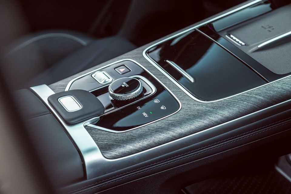 Close-up of the centre console controls in a Jaecoo J8, showing a rotary mode dial with EV and HEV drive mode indicators and surrounding buttons