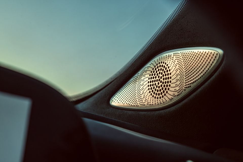 Close-up of a silver perforated speaker grille on the dashboard of a Jaecoo J8