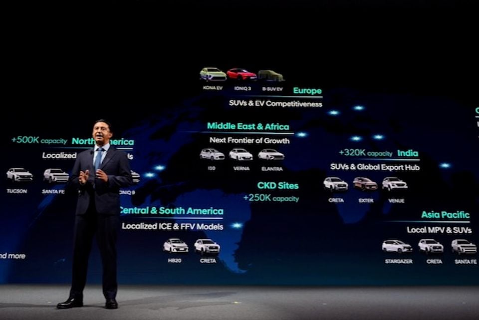 Hyundai executive Jose Munoz presents a global strategy slide showing Hyundai model lineups and production capacity targets by region, including Europe, North America, India, and Asia Pacific.