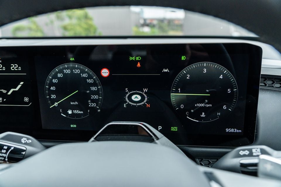 Digital instrument cluster in a Kia Tasman X-Pro showing speedometer, tachometer, compass, and trip information