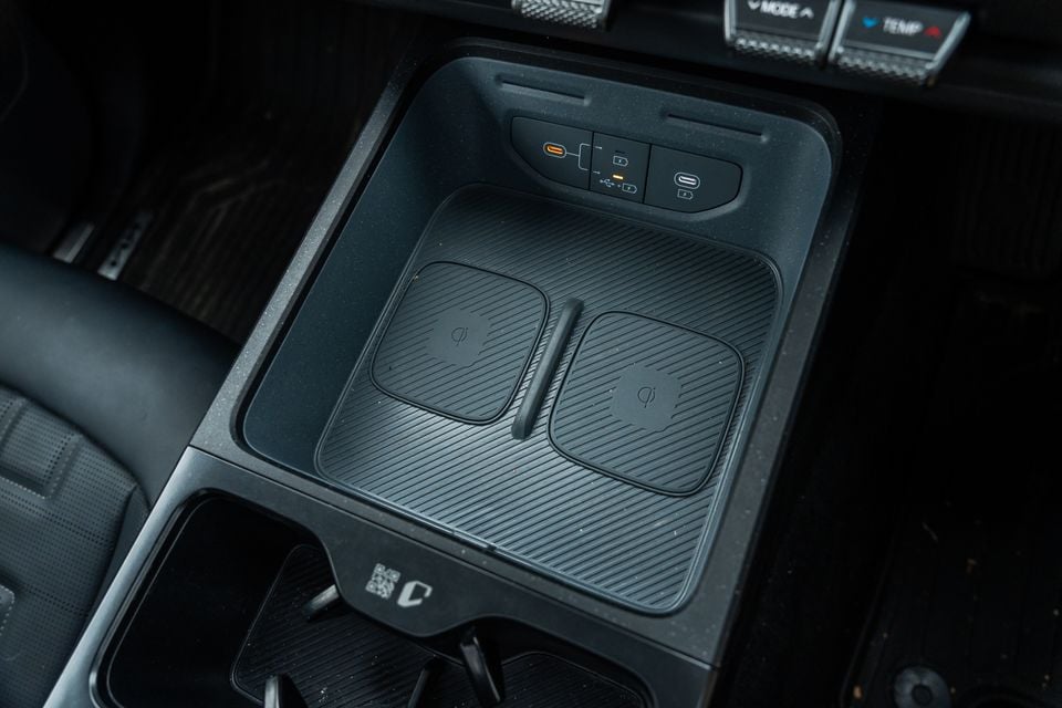 Dual wireless charging pads and USB ports in the centre console of a Kia Tasman X-Pro
