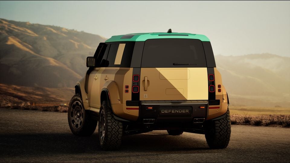 Rear view of a Land Rover Defender with a distinctive two-tone sand and teal finish, seen from behind in a desert landscape