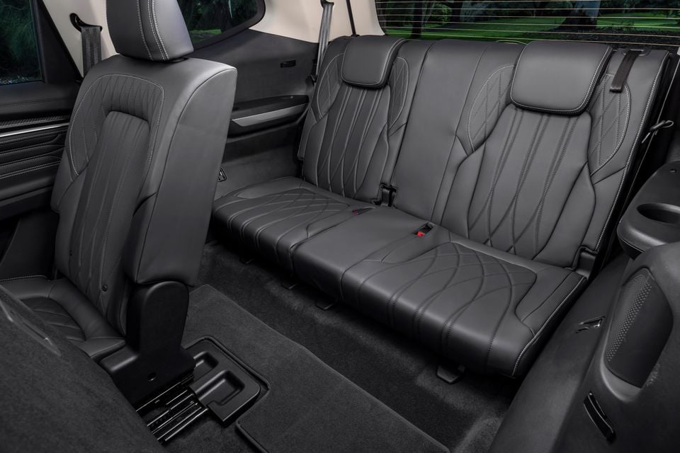 The second-row seats of an LDV D90 Luxe diesel SUV, shown in black leather upholstery with contrast stitching.