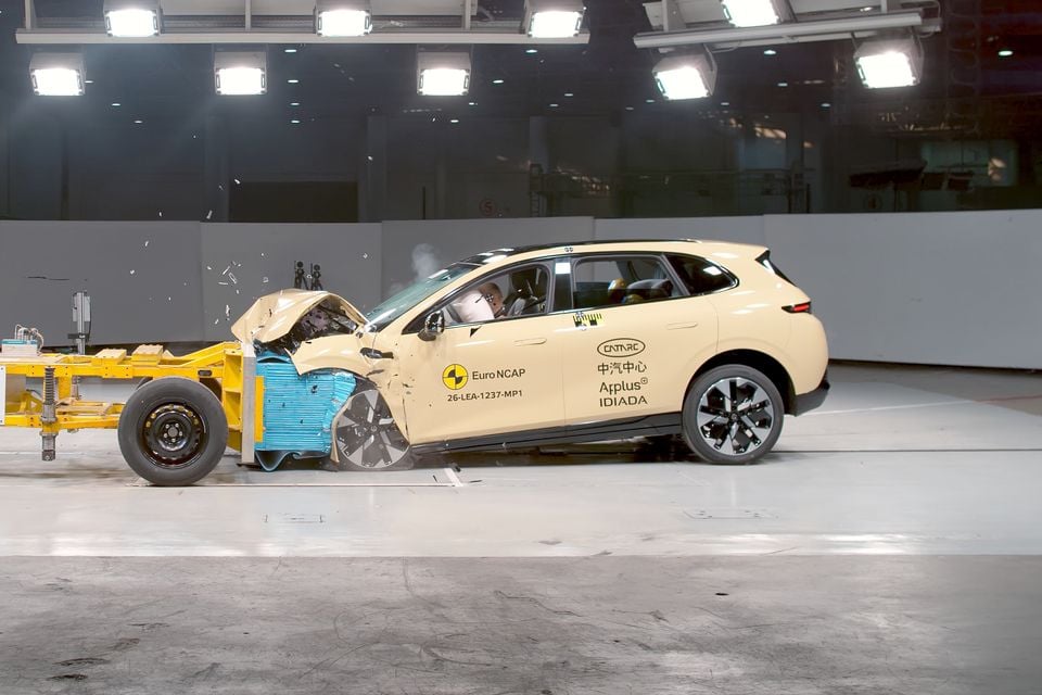 A cream Leapmotor SUV with a crumpled front end after striking a barrier during a Euro NCAP frontal crash test, seen side-on