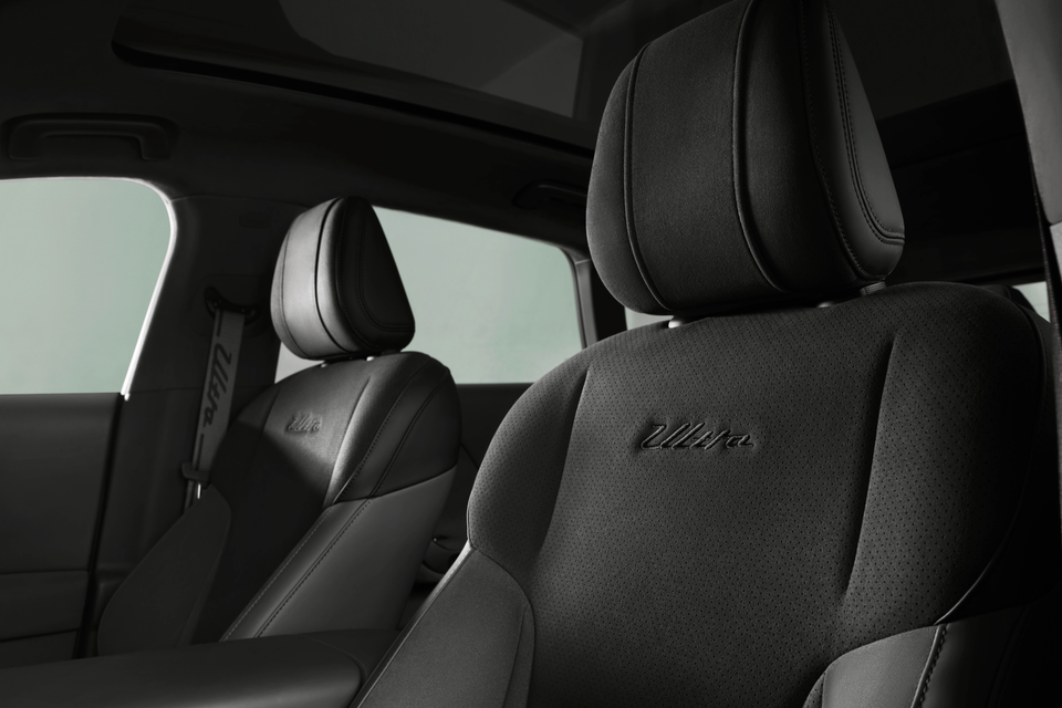 Interior view of a Leapmotor B05 LAFA Ultra showing black perforated front seats with 'Ultra' script embroidery and a panoramic sunroof visible above