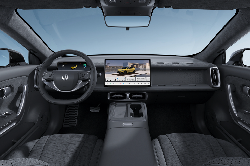 Interior of a Leapmotor B05 showing the dashboard, flat-bottomed steering wheel, large central touchscreen infotainment display, and front seats