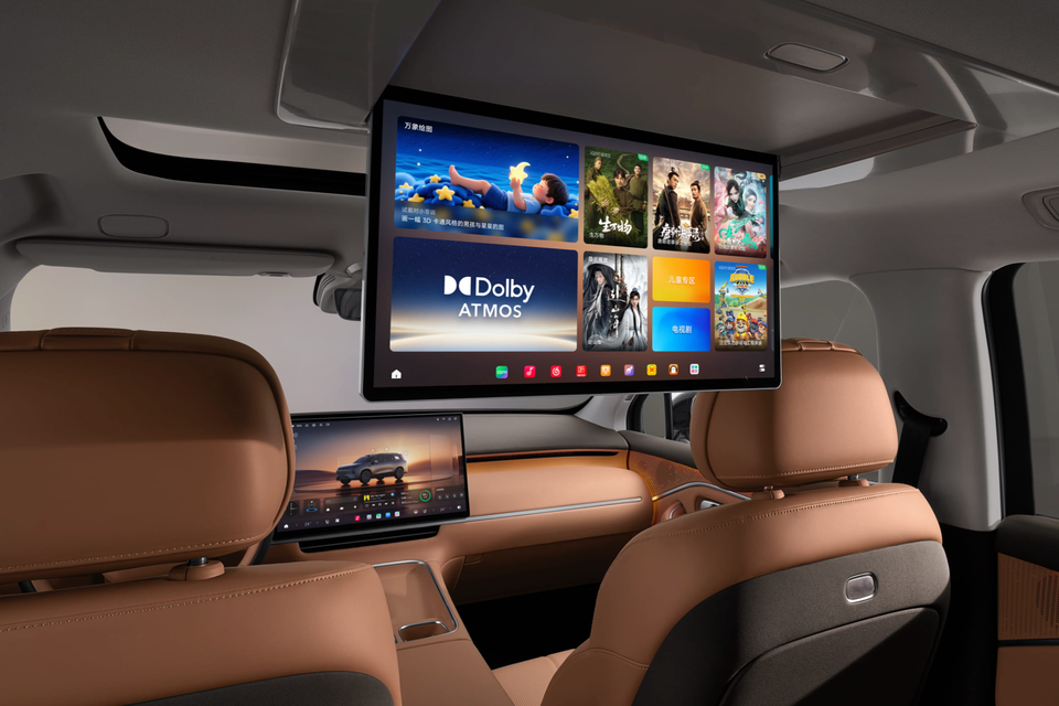Leapmotor C16 interior seen from the rear seats, with a large roof-mounted entertainment screen, tan leather front seats and a dashboard touchscreen