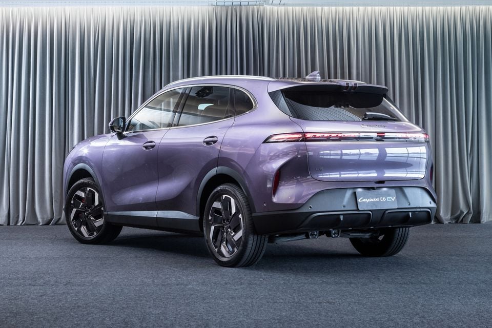 A purple Lepas L6 EV SUV seen from the rear three-quarter angle, parked indoors against a grey curtain backdrop.