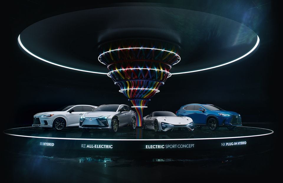 Lexus electrified vehicle lineup on a dramatic display stage, featuring the RX Hybrid, RZ All-Electric, Electric Sport Concept, and NX Plug-In Hybrid