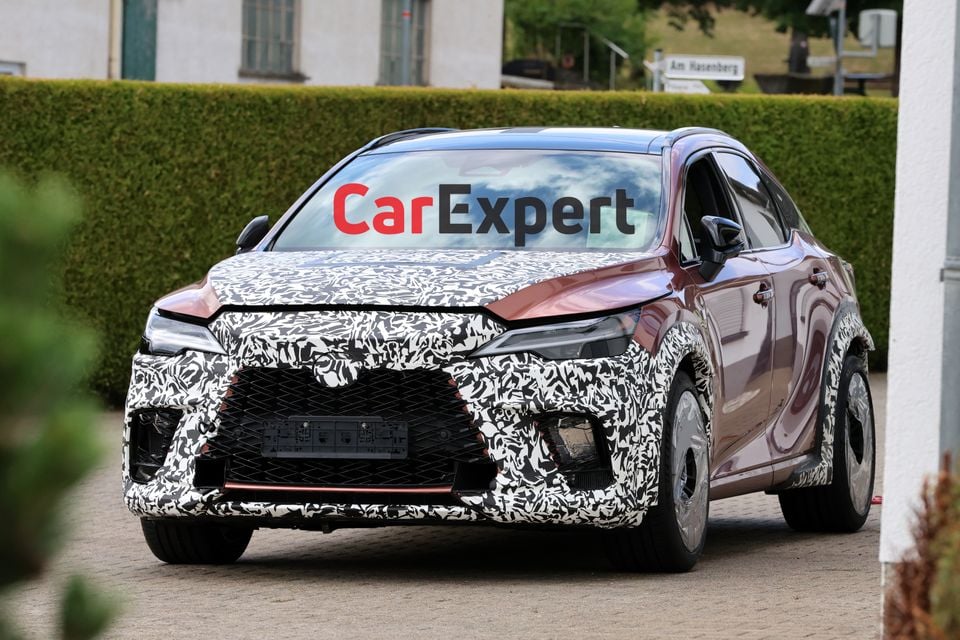 A camouflaged Lexus RX Morizo RR prototype SUV seen from the front three-quarter angle during spy photography