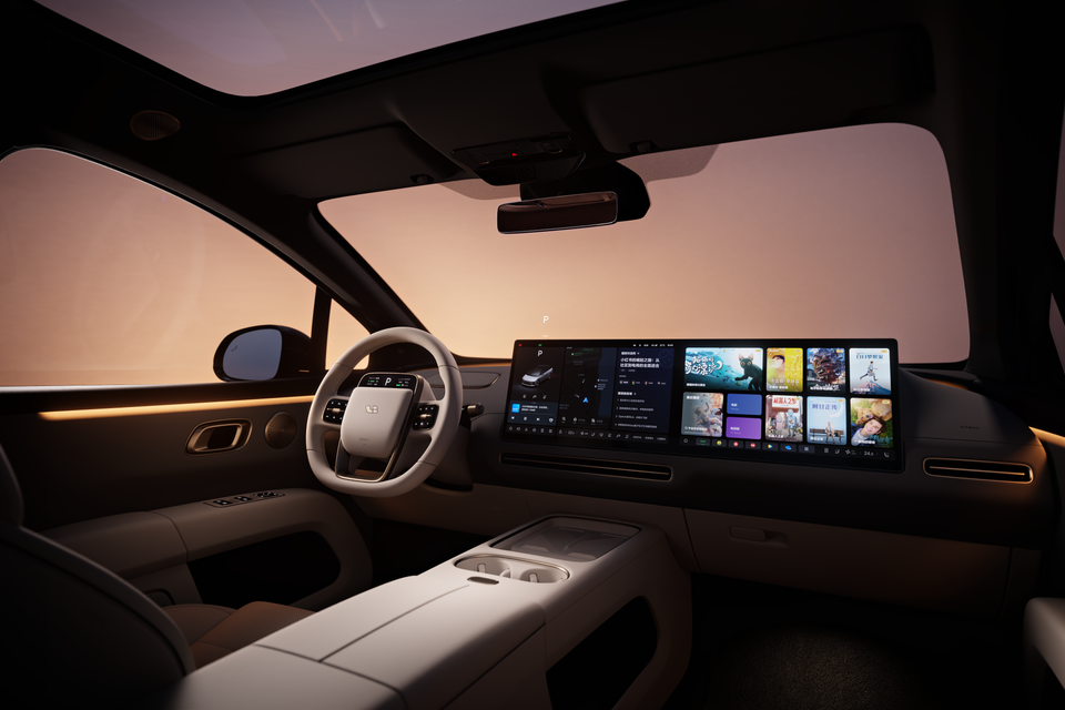 Interior of a Li Auto i6 showing the front cabin with a large widescreen infotainment display, minimalist dashboard, and steering wheel