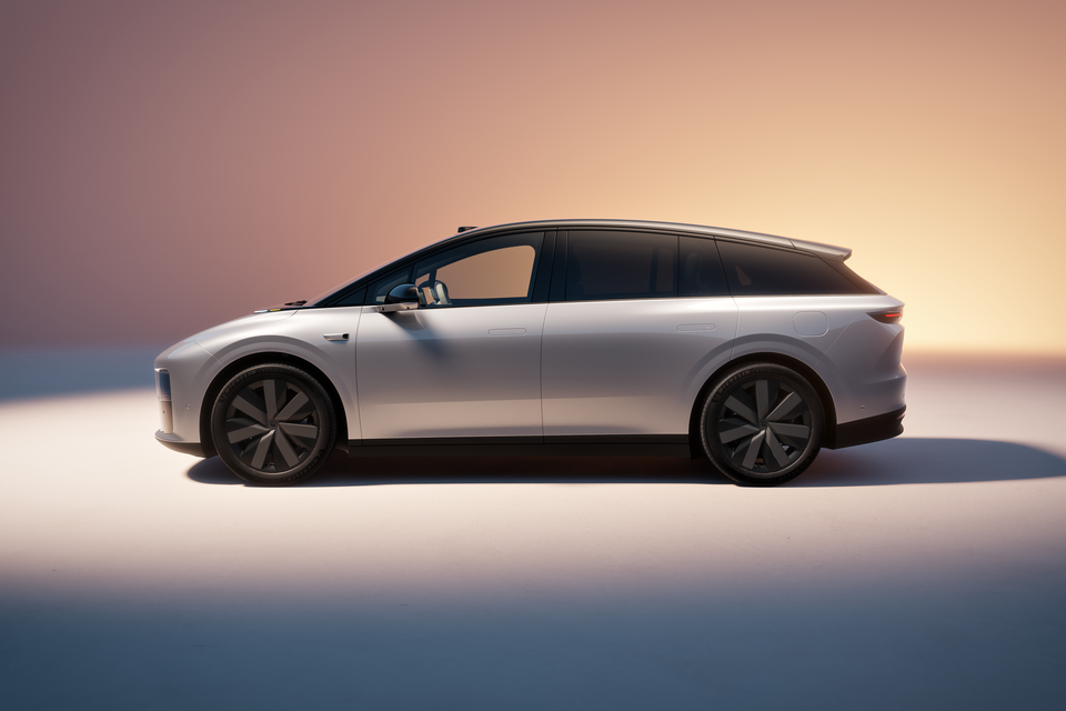A silver Li Auto i6 large electric SUV wagon seen from the side in a studio setting