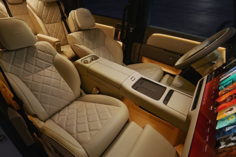 Luxury quilted cream leather interior of a Li Auto Mega, showing captain's chairs, centre console and steering wheel