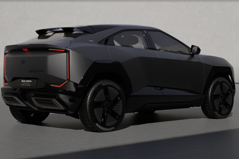 A black Mahindra BE 6 Sporteq Launch Edition SUV seen from the rear three-quarter angle, showing its angular design and red-accented tail lights
