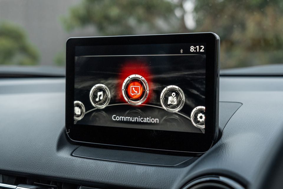 Mazda CX-3 infotainment screen showing the Communication menu with music, navigation and settings icons visible