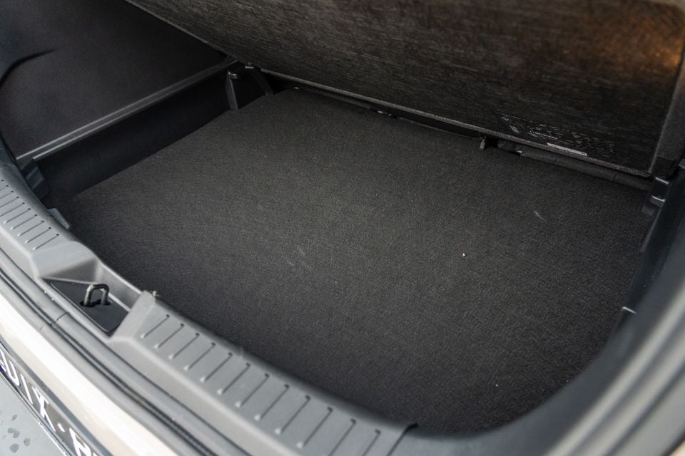 Empty carpeted boot of a Mazda CX-3 with the parcel shelf raised, viewed from the rear