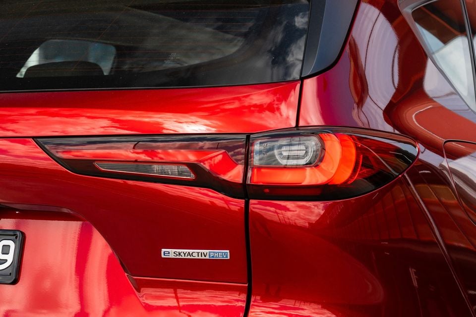 Close-up of the rear tail light and e-Skyactiv PHEV badge on a red Mazda CX-60 SUV