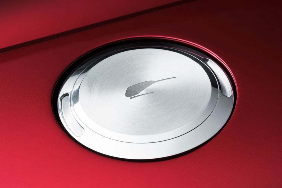 Close-up of the polished aluminium fuel filler cap on a red McLaren MCL6GT