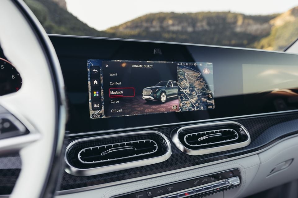 The Mercedes-Maybach GLS 680 infotainment screen showing the Dynamic Select drive mode menu with Maybach mode selected, with dashboard air vents visible below