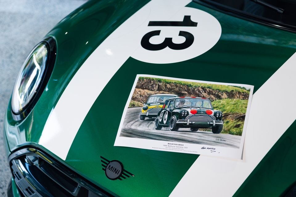 Bonnet of a green Mini Cooper Lucky 13 Edition with white stripes and number 13, holding a print of Minis racing at the 1966 Bathurst Gallaher 500