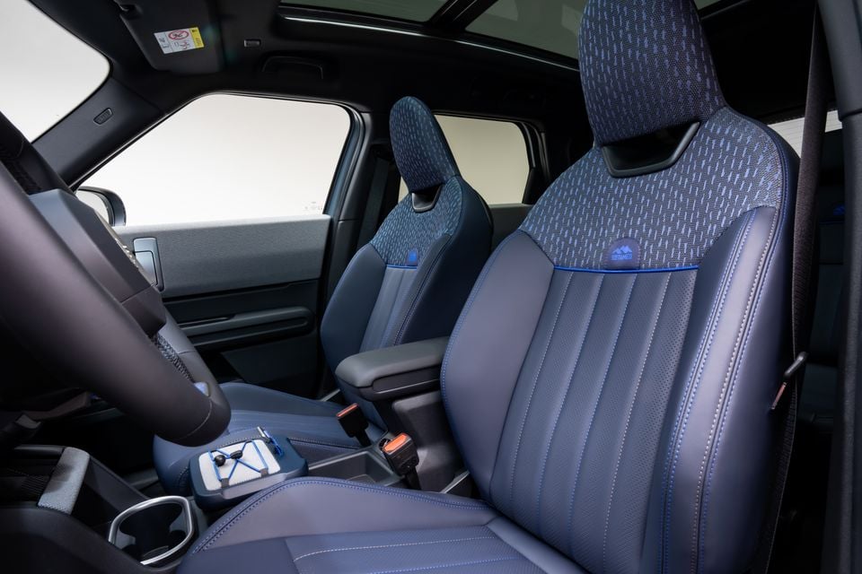 The blue and patterned front seats of a Mini Countryman Untamed Edition, seen from inside the cabin.