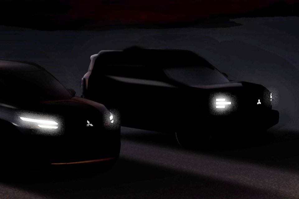 Two silhouetted Mitsubishi concept vehicles shown in a dark teaser image, with illuminated headlights and Mitsubishi logos visible on both