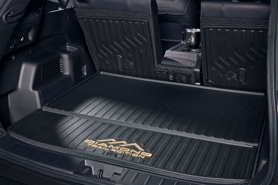 Boot of the Mitsubishi Outlander Diamond Trail Edition with branded rubber cargo mat and third-row seatbacks folded flat