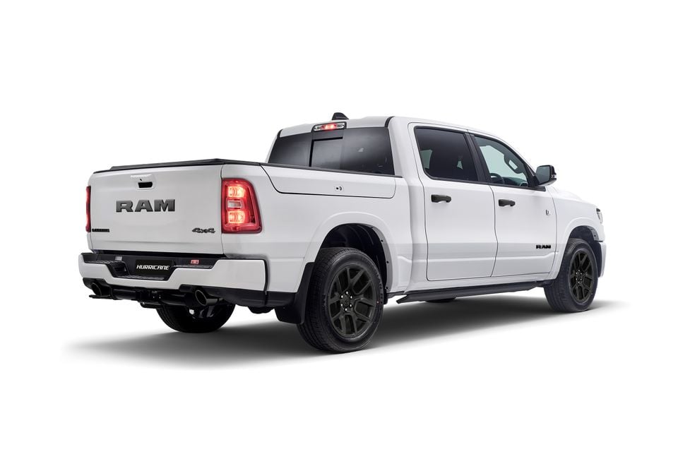 White Ram 1500 Laramie Night Edition ute seen from the rear three-quarter angle, featuring black alloy wheels and blacked-out badging on a white background