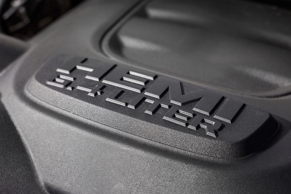 Close-up of a "5.7 Hemi liter" engine cover badge on a Ram 2500 Warlock's V8 engine